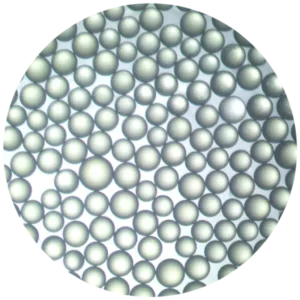 Close-up of a dense cluster of small metallic spheres with a pearly finish, forming a circular field.