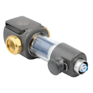 Industrial valve with transparent chamber, grey body, and brass fittings on a plumbing setup